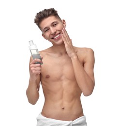 Handsome man applying lotion onto his face on white background
