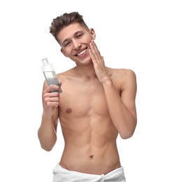 Photo of Handsome man applying lotion onto his face on white background