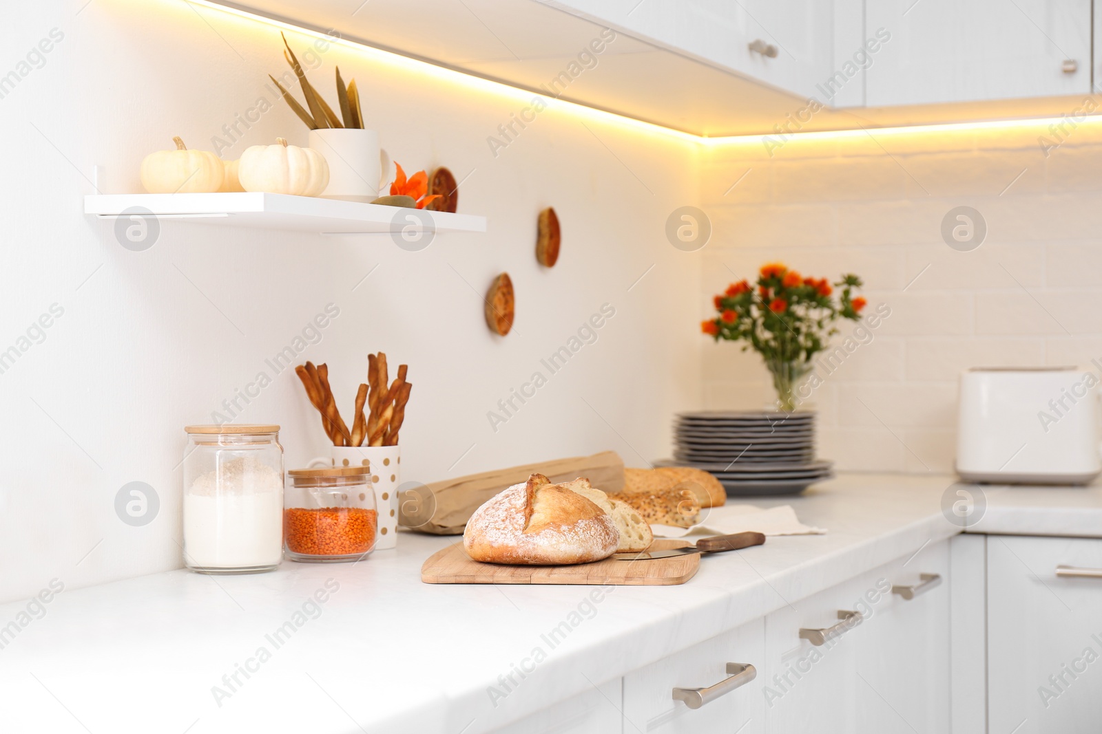 Photo of Modern kitchen interior with products on counter