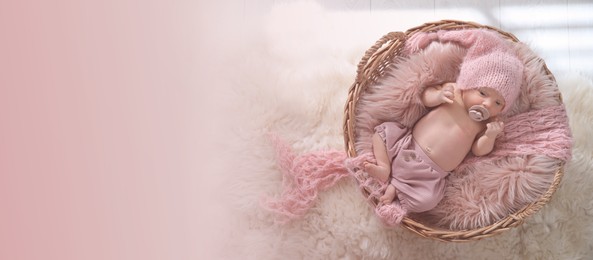 Adorable newborn baby with pacifier in wicker basket, top view with space for text. Banner design