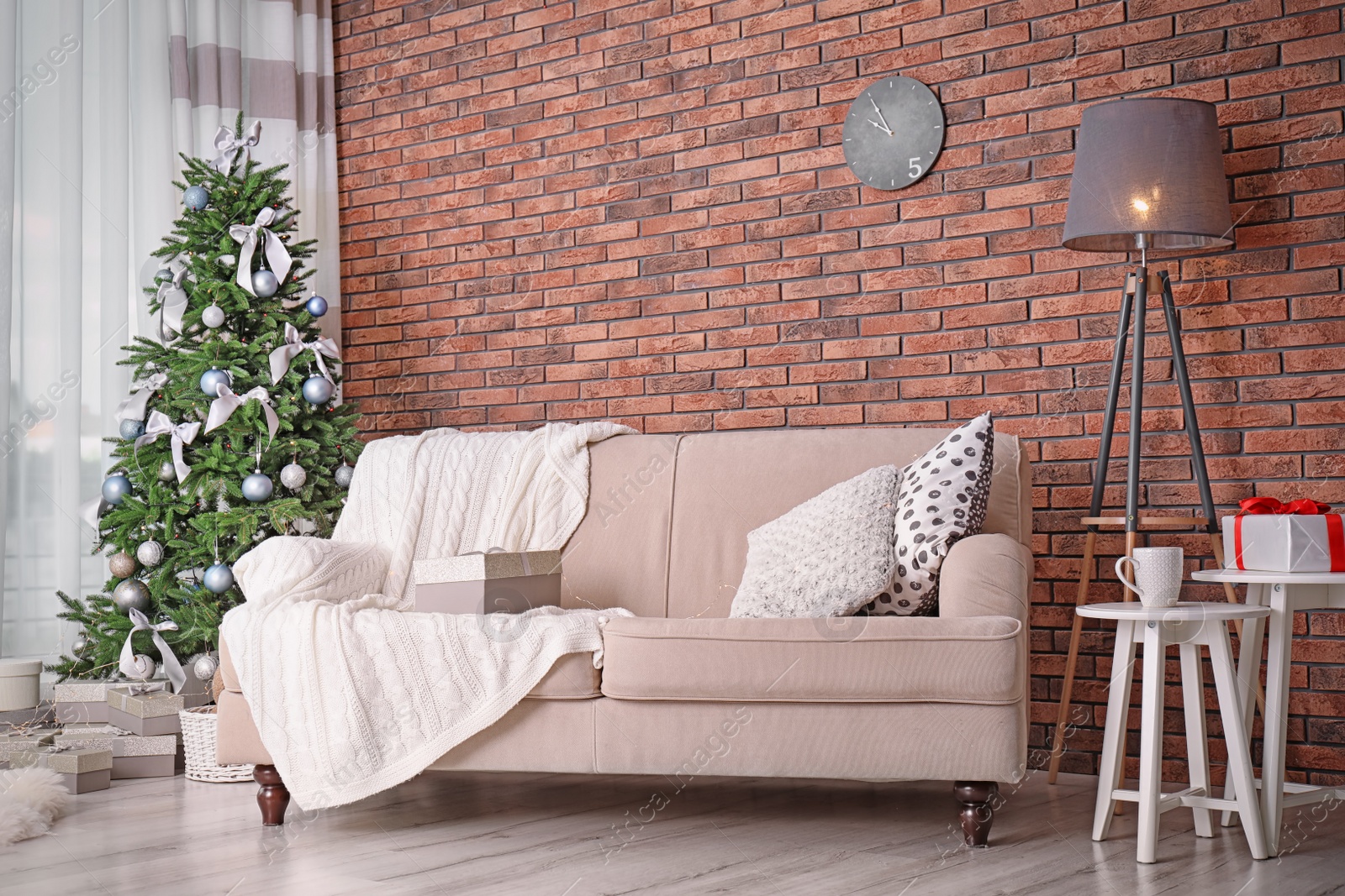 Photo of Decorated Christmas tree in stylish living room interior