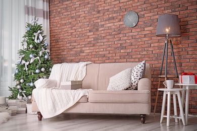 Decorated Christmas tree in stylish living room interior