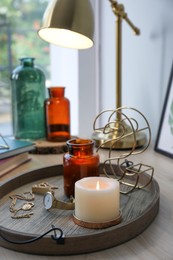 Stylish tray with different interior elements on wooden table near window