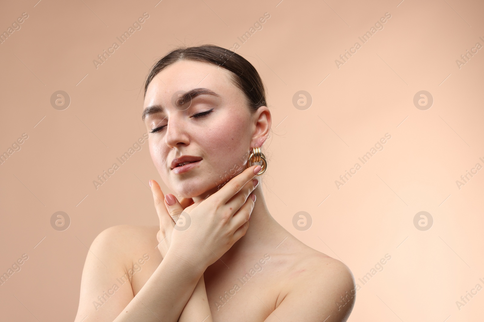 Photo of Portrait of beautiful young woman on beige background