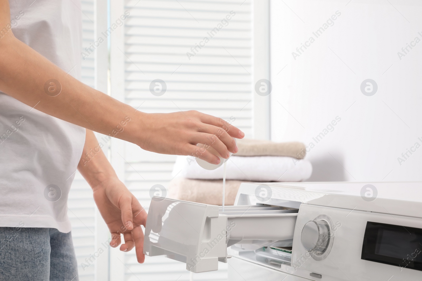 Photo of Woman doing laundry at home, closeup on hands