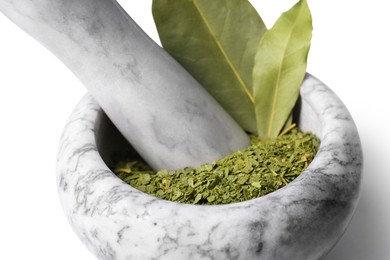 Photo of Marble mortar with whole and ground bay leaves on white background, closeup