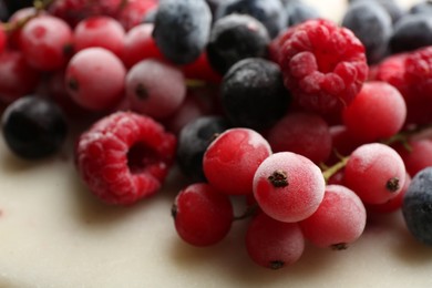 Mix of tasty frozen berries on table, closeup