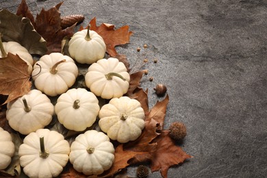 Photo of Flat lay composition with ripe pumpkins on grey textured table. Space for text