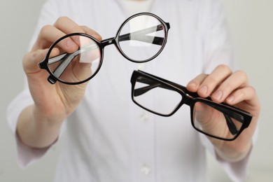 Photo of Woman with different glasses on light background, closeup