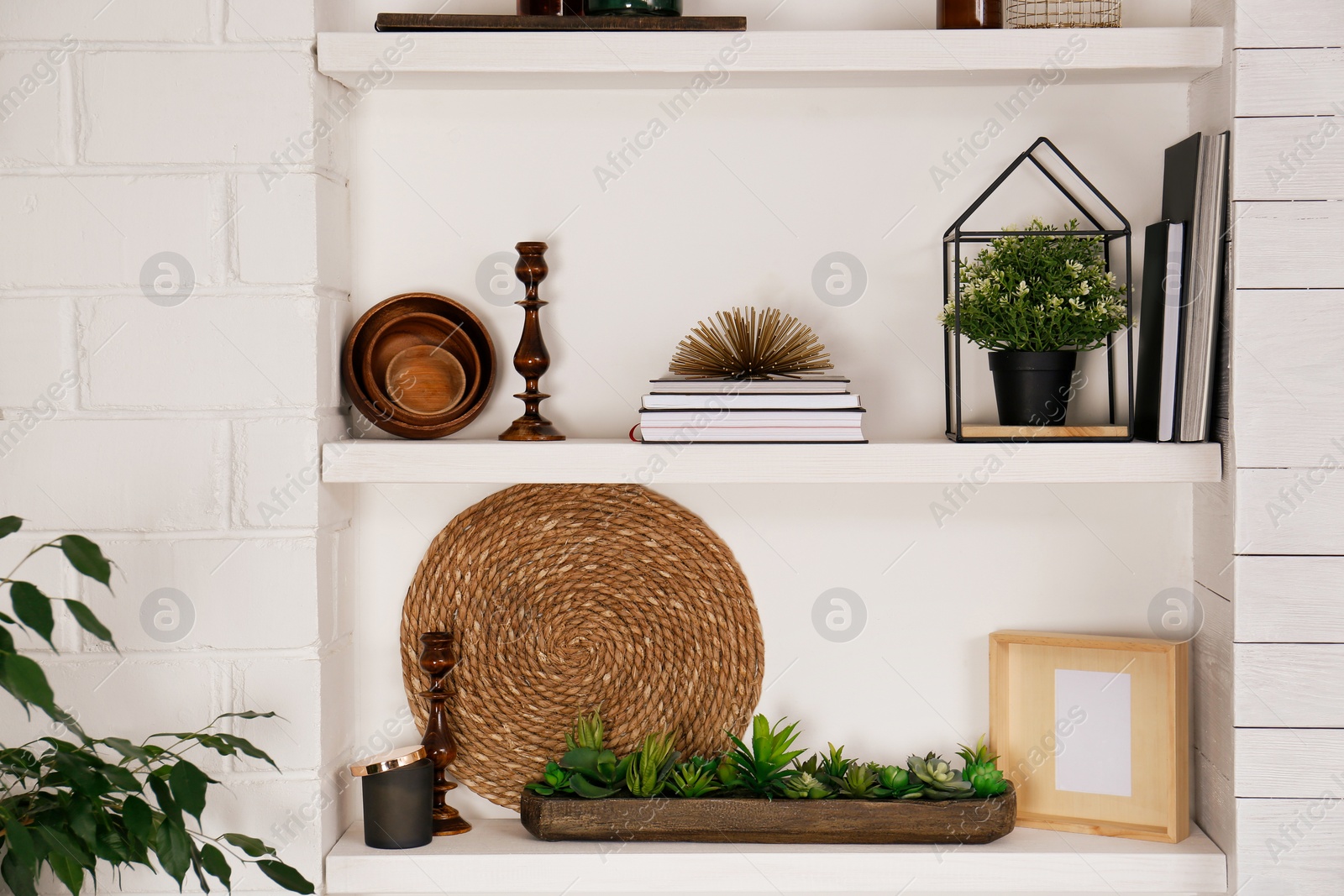 Photo of Wall shelves with beautiful decor elements indoors. Interior design