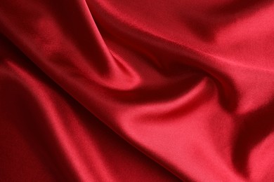 Photo of Texture of beautiful red silk fabric as background, closeup