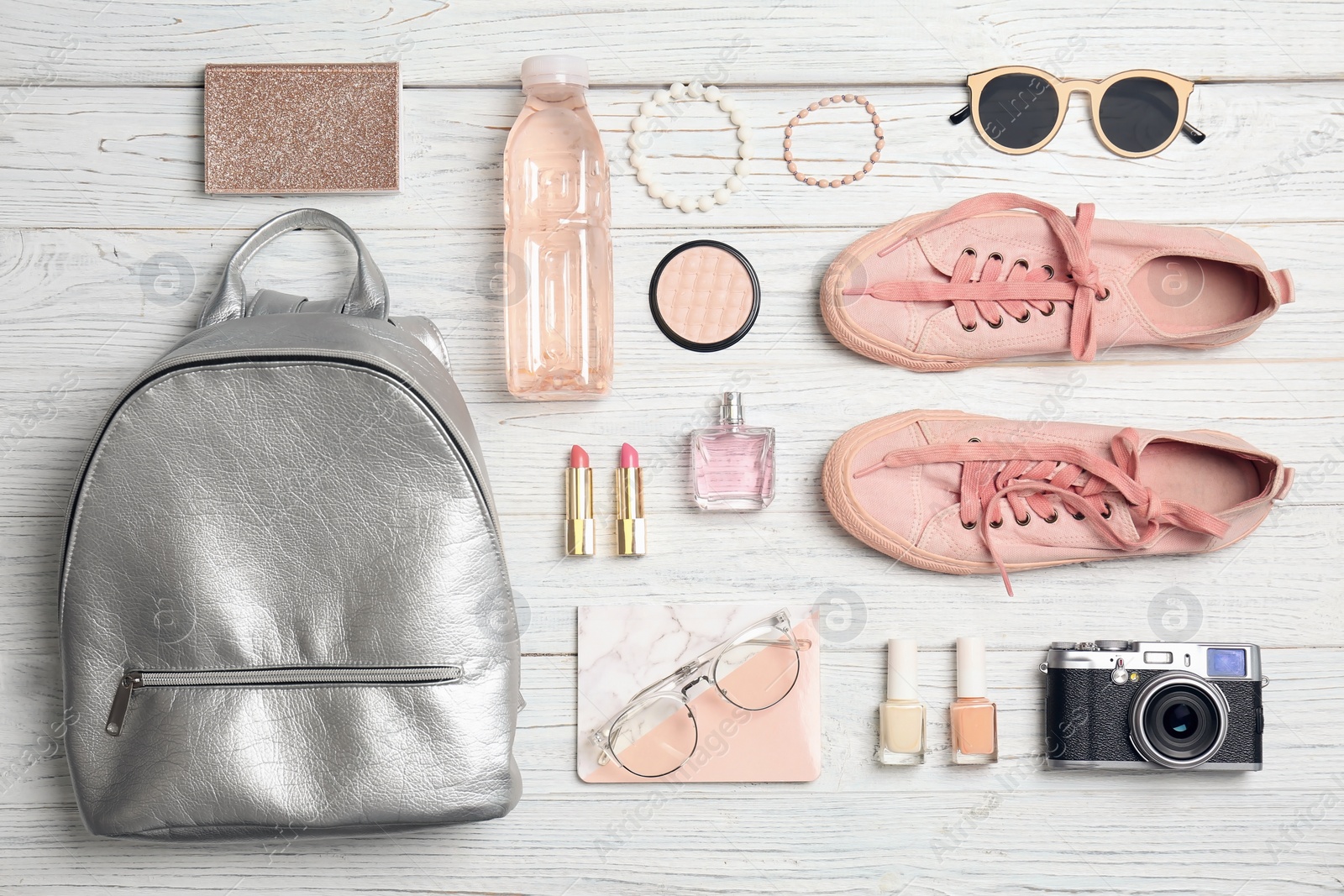 Photo of Flat lay composition with stylish accessories and camera on light background