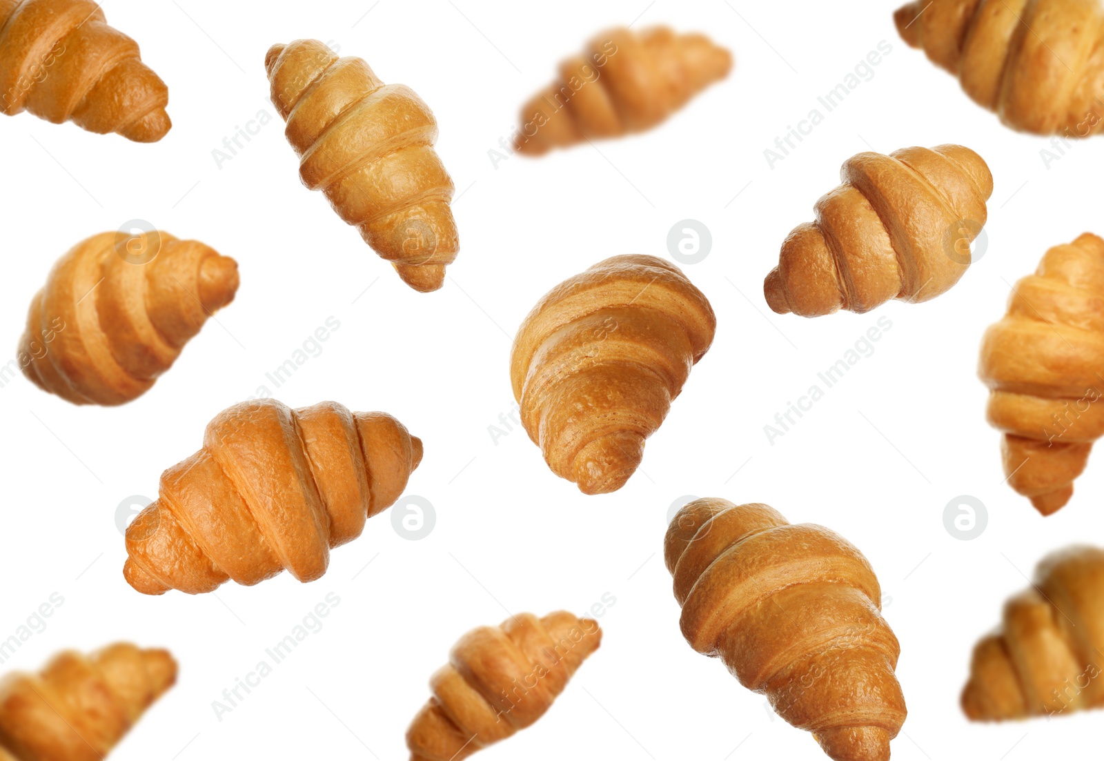 Image of Crusty golden croissants falling on white background