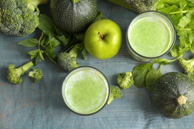 Flat lay composition with healthy detox smoothie and ingredients on wooden background