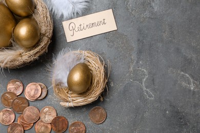 Photo of Many golden eggs, coins and card with word Retirement on grey table, flat lay. Pension concept