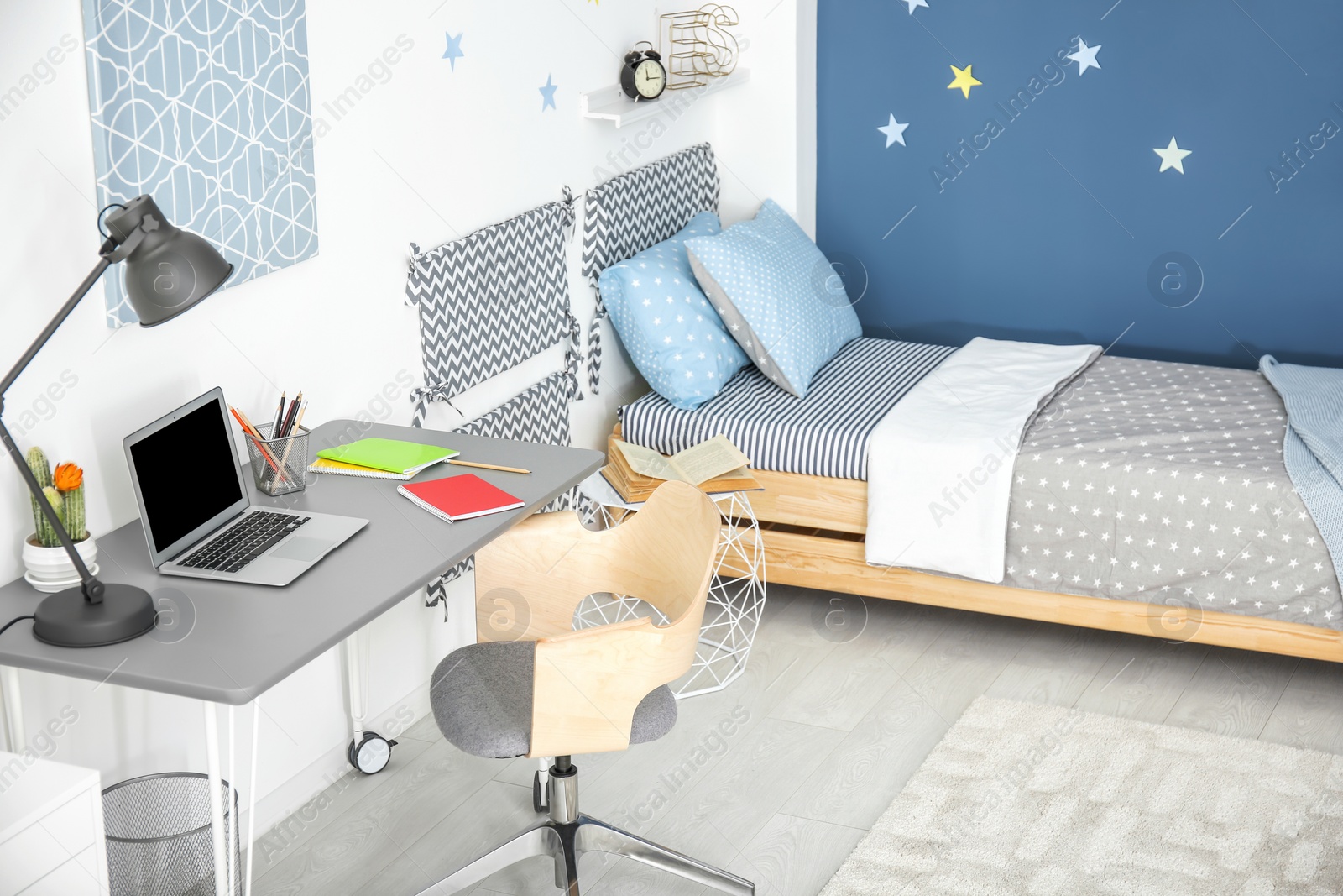 Photo of Modern child room interior with comfortable bed and desk