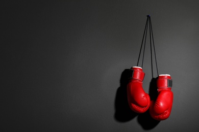 Pair of boxing gloves on grey background, space for text