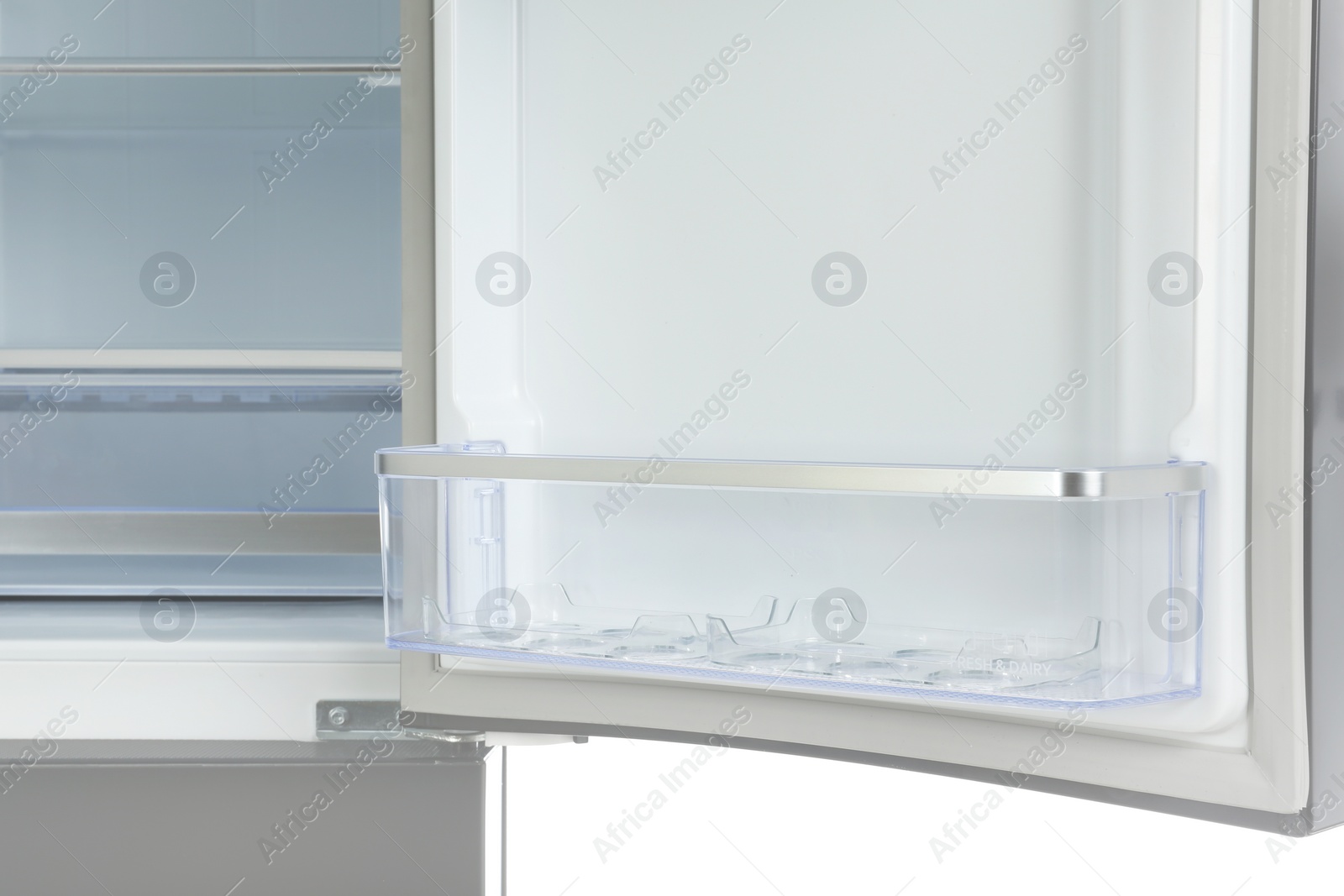 Photo of Door shelf of empty modern refrigerator, closeup view