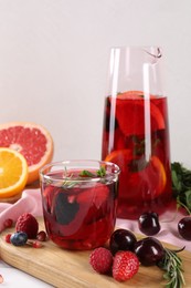 Delicious refreshing sangria and ingredients on table
