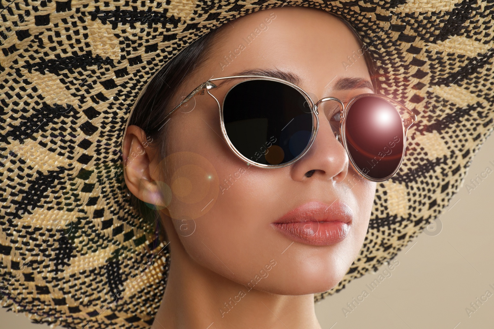 Image of Beautiful young woman wearing sunglasses and hat on beige background, closeup