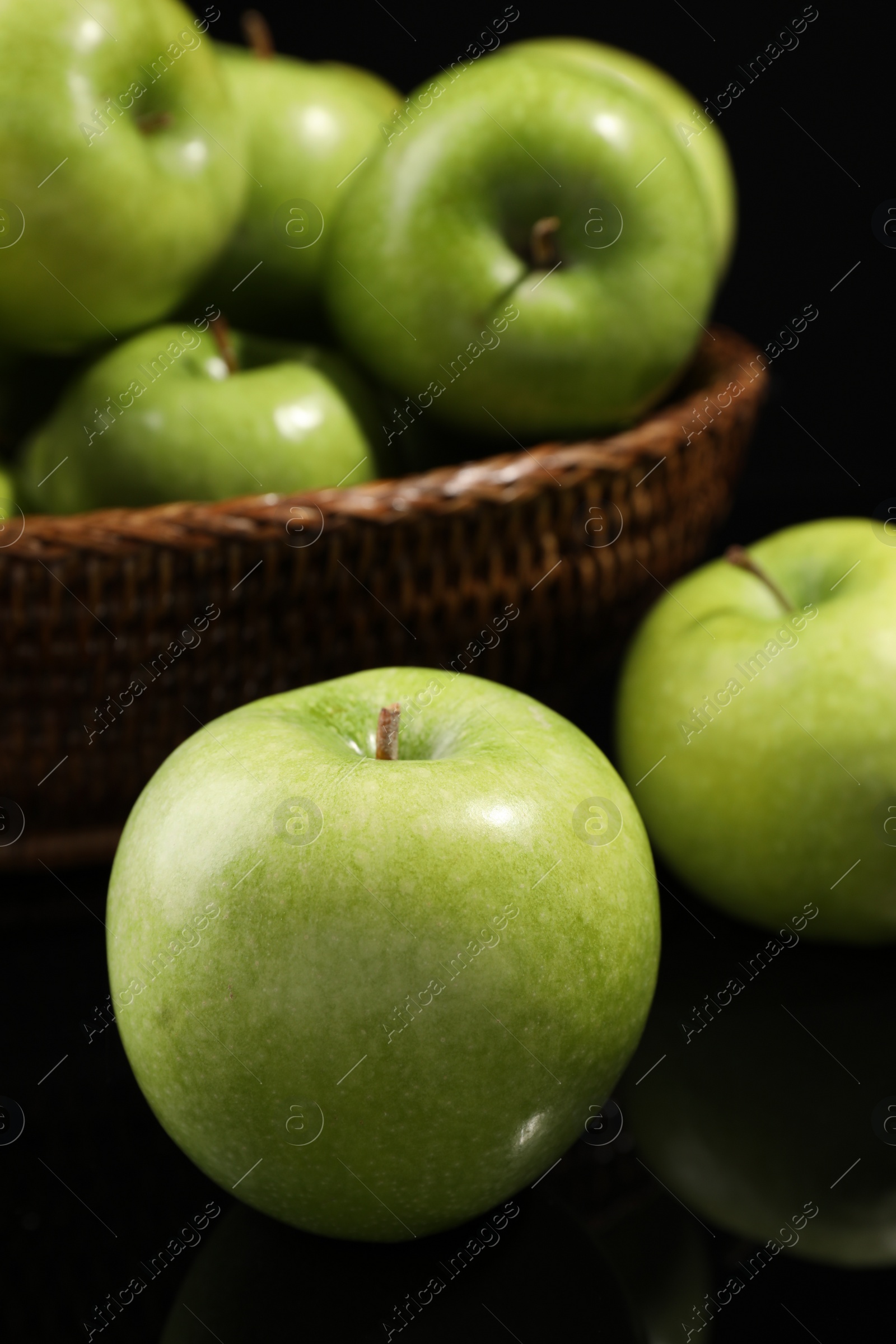 Photo of Delicious ripe green apples on black background