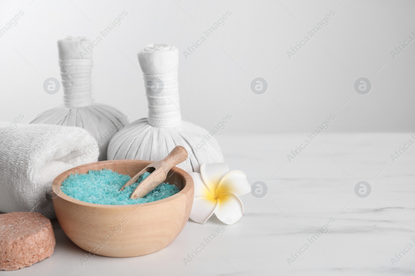 Photo of Spa composition with care products on white marble table. Space for text