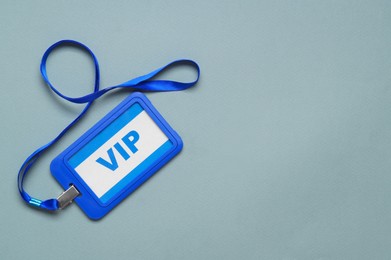 Photo of Plastic vip badge on light background, top view. Space for text