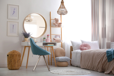 Photo of Teenage girl's bedroom interior with stylish furniture. Idea for design