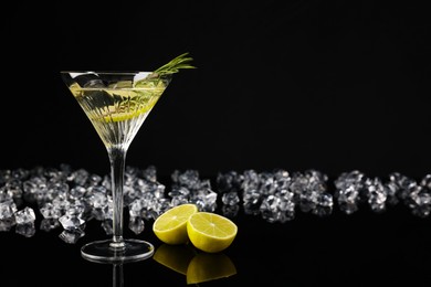 Photo of Martini cocktail and ice cubes on black background, space for text