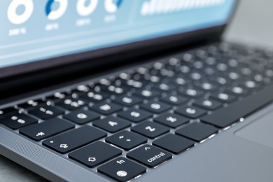 Photo of Laptop on light grey background, closeup. Modern technology