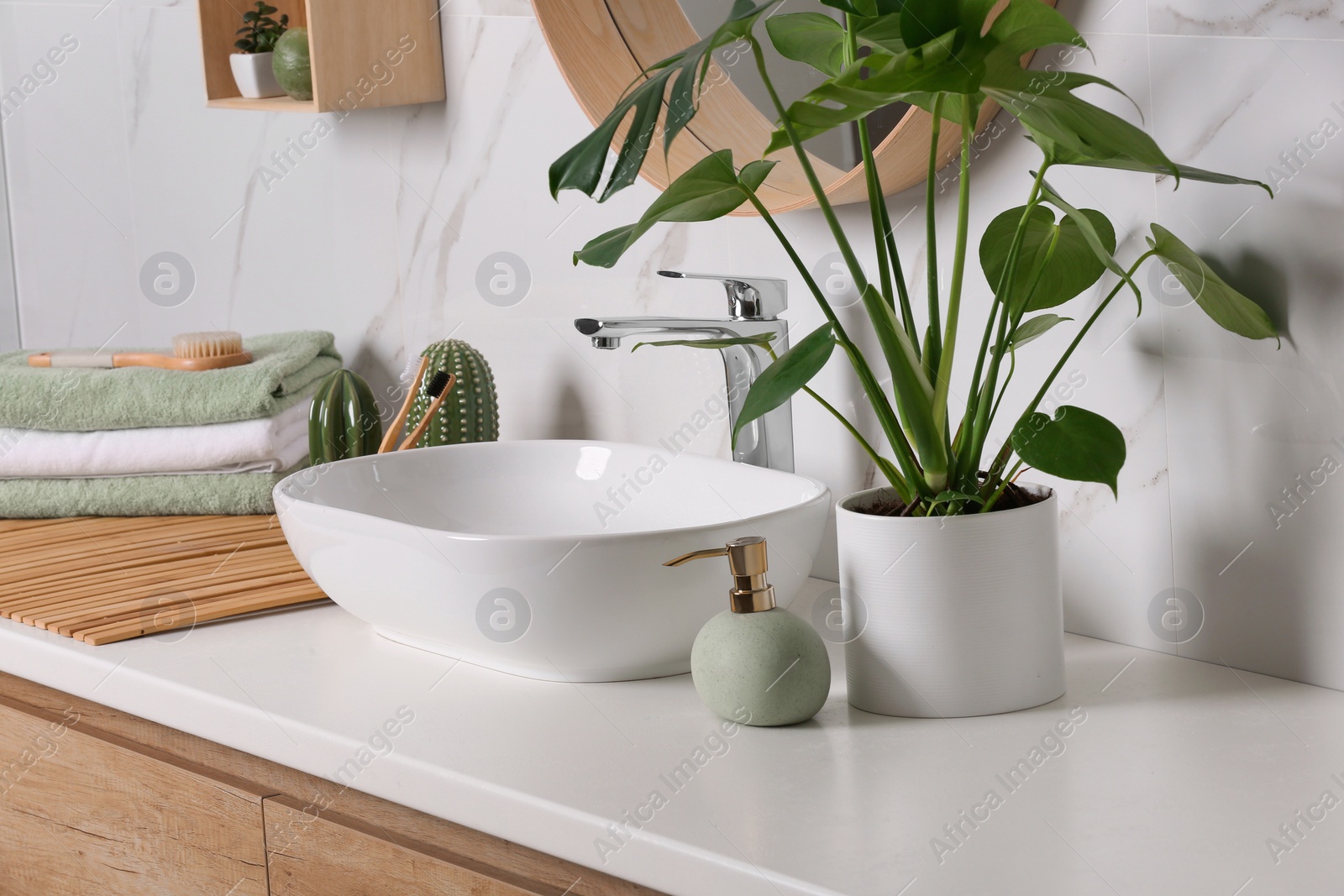 Photo of Stylish vessel sink on light countertop in modern bathroom