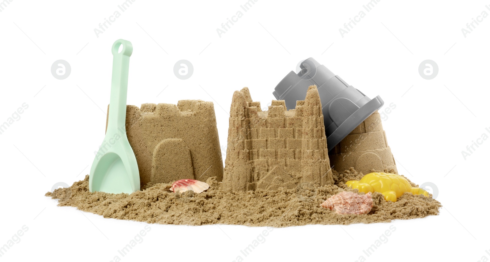 Photo of Beautiful sand castles, shells and plastic beach toys isolated on white