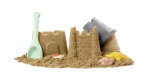 Beautiful sand castles, shells and plastic beach toys isolated on white