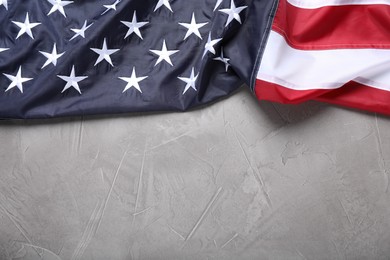 Photo of National flag of America on light grey table, top view. Space for text