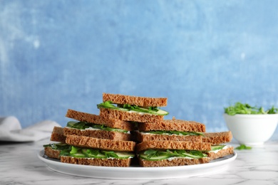 Photo of Plate with traditional English cucumber sandwiches on table. Space for text