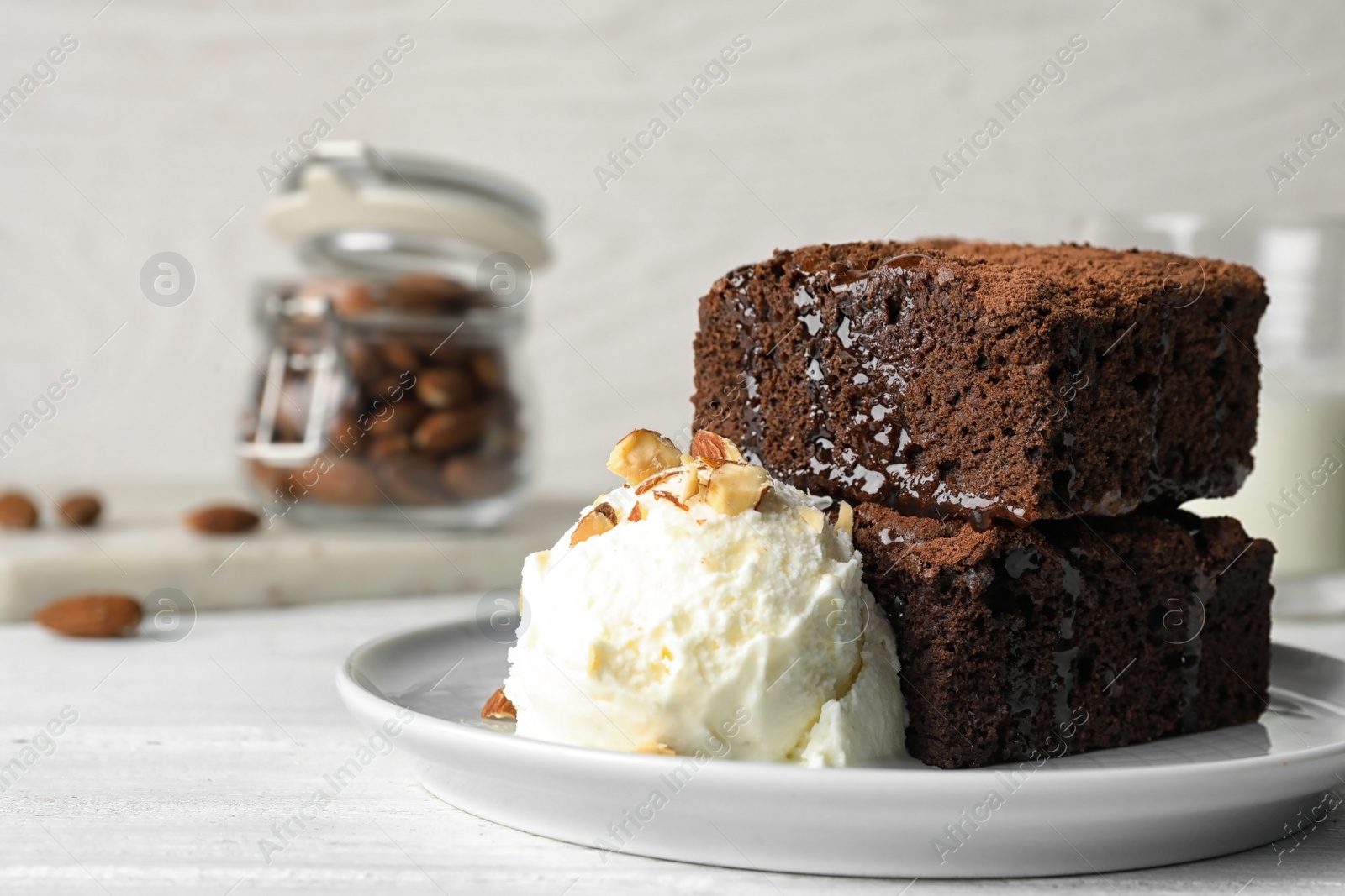 Photo of Plate with fresh brownies and ice-cream on table, space for text. Delicious chocolate pie