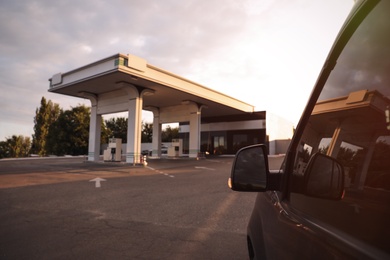 Photo of Modern car near gas filling station, closeup