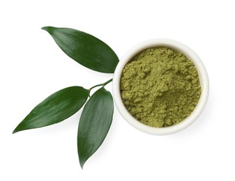 Photo of Henna powder in bowl and green leaves isolated on white, top view