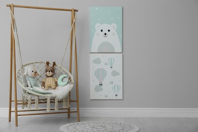 Photo of Stylish child's room interior with adorable paintings and hanging chair. Space for text