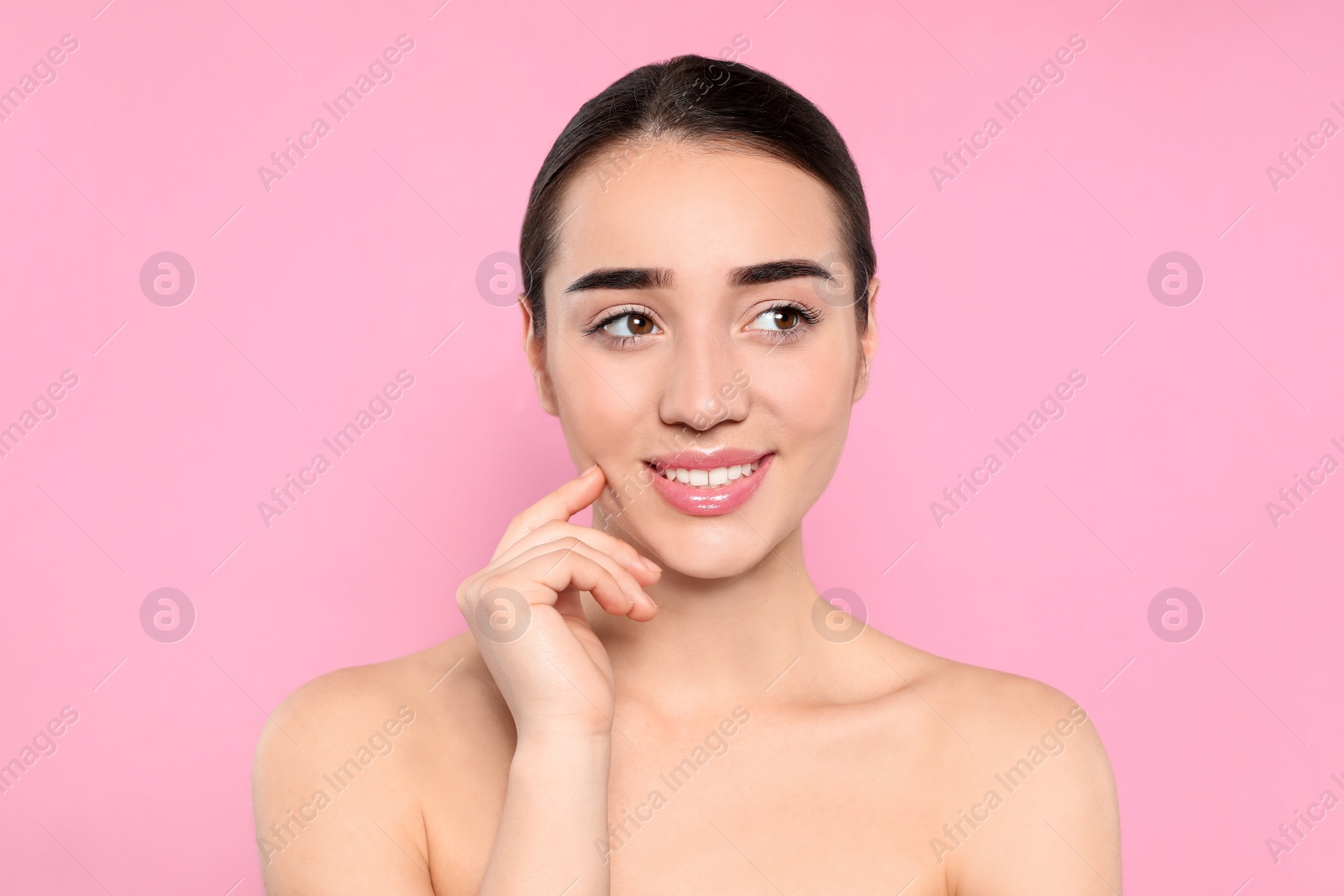 Photo of Portrait of young woman with beautiful face against color background