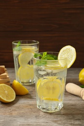 Glasses of natural lemonade with mint on table