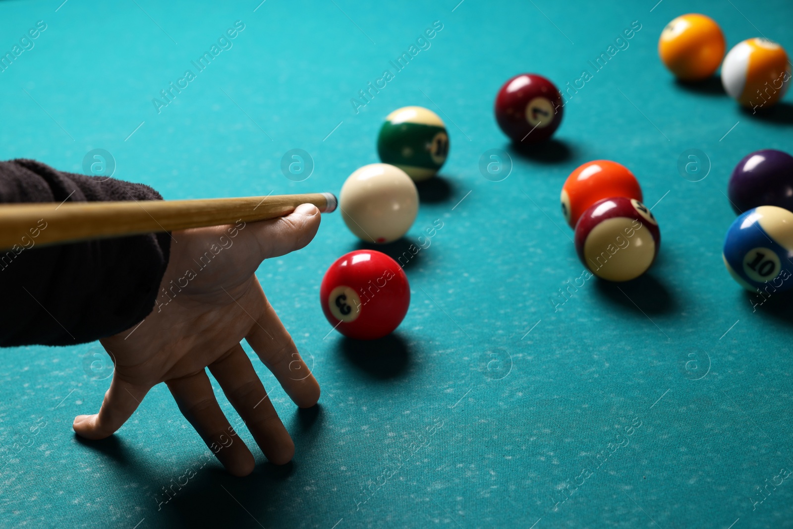 Photo of Man playing billiard at green table, closeup