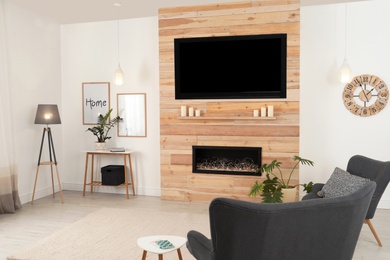 Living room interior with decorative fireplace in wooden wall