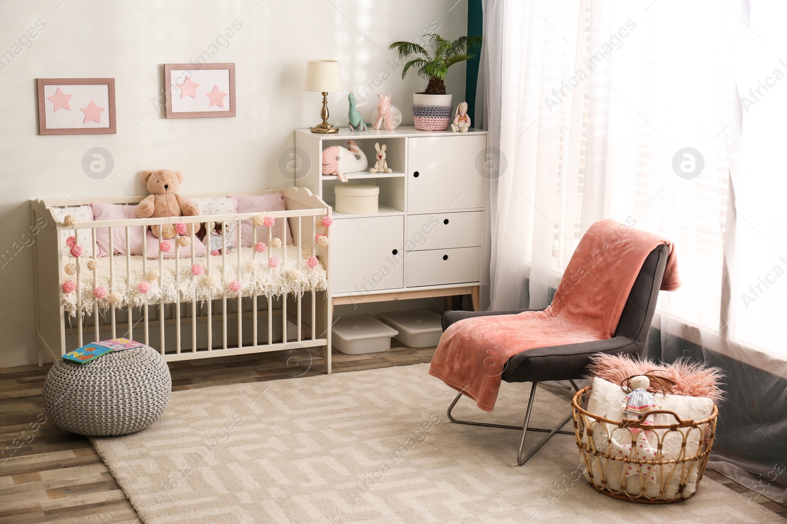 Photo of Cozy baby room interior with comfortable crib