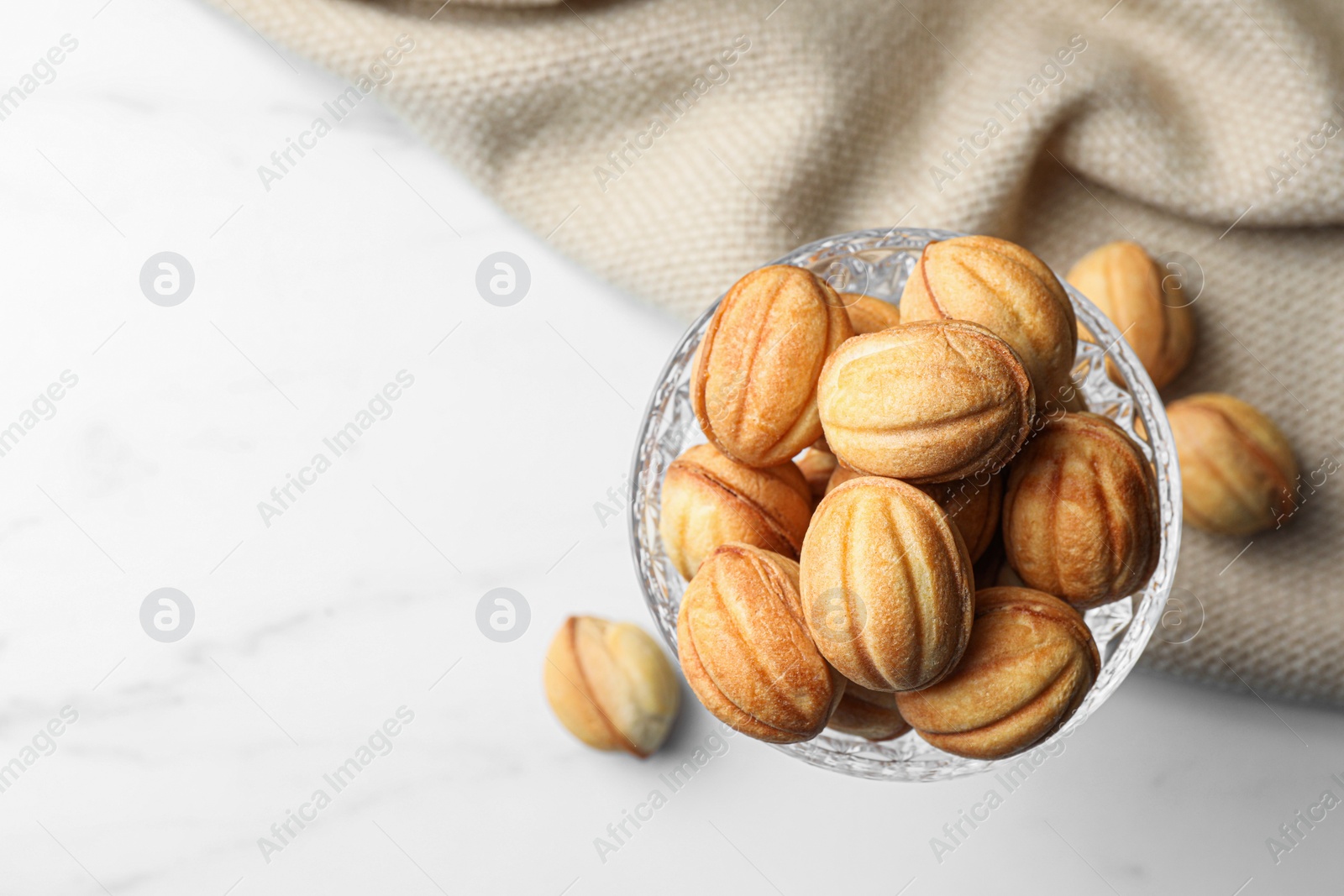 Photo of Delicious nut shaped cookies on white table, flat lay. Space for text