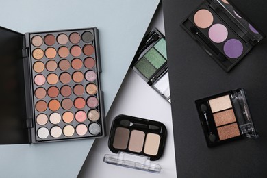 Photo of Many different eye shadow palettes on colorful background, flat lay