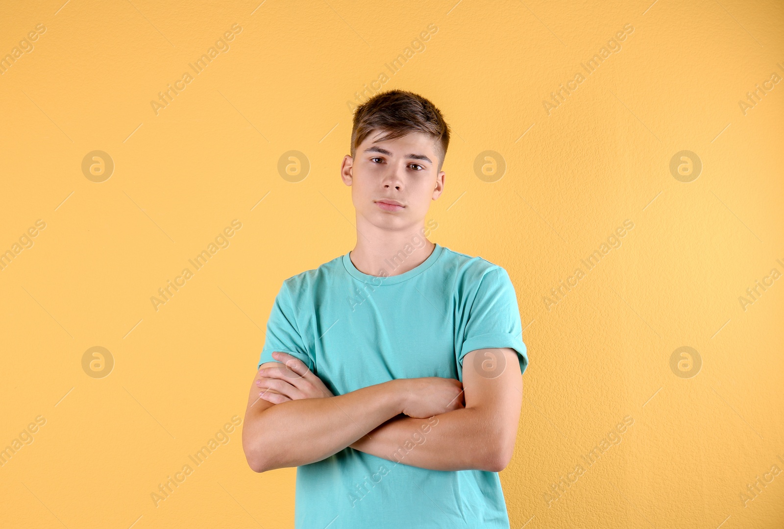 Photo of Teenage boy in casual clothes on color background