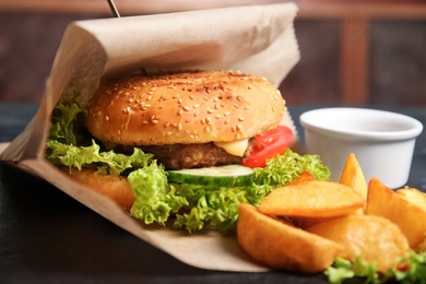 Photo of Tasty burger and fries, closeup