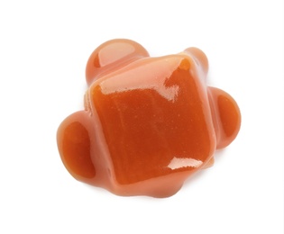 Delicious candy with caramel sauce on white background, top view
