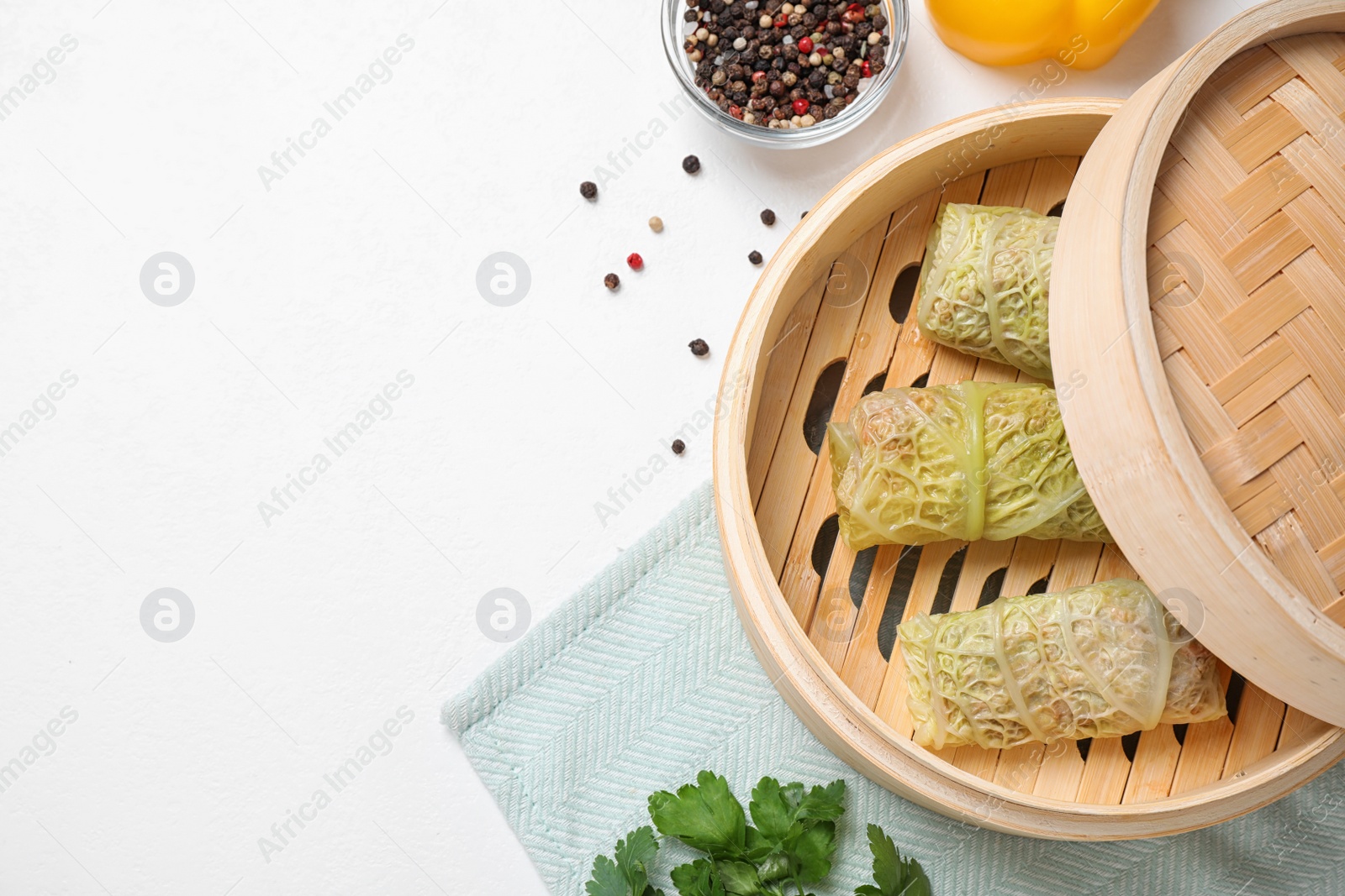 Photo of Delicious cabbage rolls served on white table, flat lay. Space for text